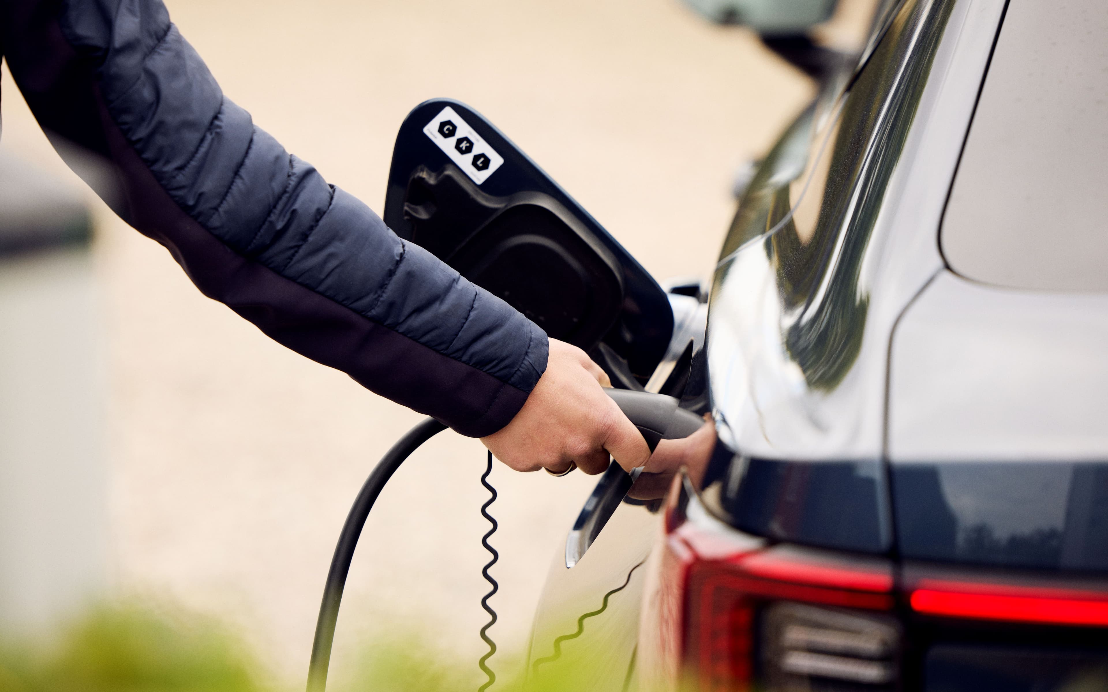 Hand plugging in AC cable